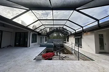 Mansard courtyard pool enclosure by East Coast Aluminum